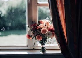 Sunlight streaming through a window illuminating a bouquet of colorful flowers on a windowsill photo