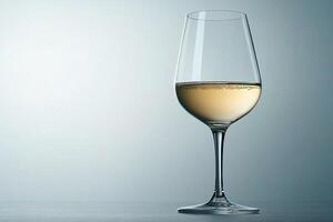 minimalistic photo of glass of white wine on neutral plain grey background with copy space