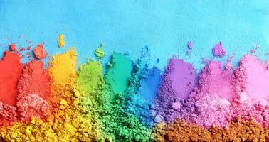 A striking abstract design presents a vivid spectrum of colored powder layers ranging from red to purple, set against a bright blue backdrop, evoking creativity and energy photo