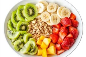 A beautifully arranged bowl showcases a medley of fresh fruits including green kiwi slices, ripe strawberries, banana rounds, and crunchy oats. Perfect for a nutritious morning treat photo