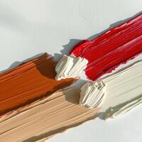 Abstract paint strokes in red, brown, beige and white photo