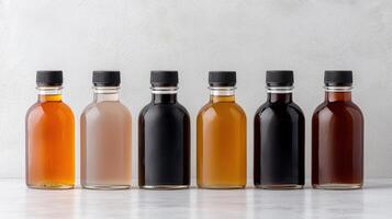 Six bottles of different colored liquids on a white background photo