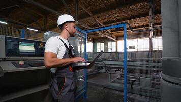 Engineer Programmer With Laptop On Industrial Factory Analyzes The Production Process video
