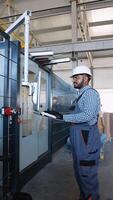 Engineer working at programmable CNC machine in factory industries video
