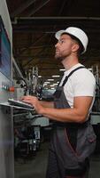 Engineer working at programmable CNC machine in factory industries video