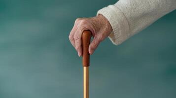Caregiving elderly compassion concept. Supportive hand gripping a walking cane for stability. photo