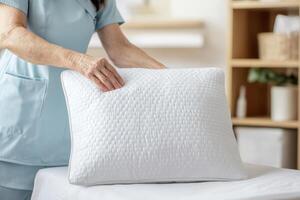 Caregiving elderly compassion concept. Caregiver adjusting a pillow in a serene environment. photo