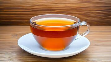 A steaming cup of tea on a wooden surface. photo
