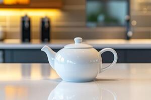 Elegant white teapot on a modern kitchen countertop. photo