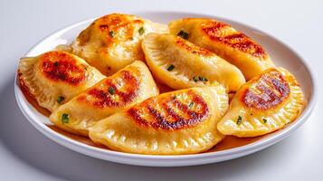 Delicious golden-brown dumplings served on a white plate. photo
