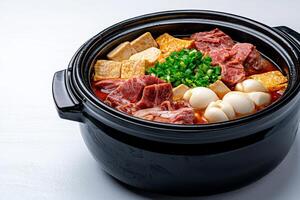 Delicious hot pot with assorted meats and vegetables. photo