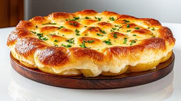 Delicious golden bread topped with herbs on a wooden platter. photo