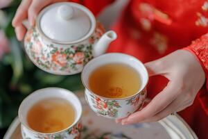 Chinese family reunion concept. Traditional tea service with floral teapot and cups. photo