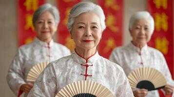 Focus on senior health concept. Three elderly women holding fans in traditional attire. photo