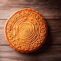 Chinese family reunion concept. Deliciously baked round pastry with intricate design. photo