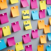 Funding with startup ecosystem concept. Colorful sticky notes organized on a board for brainstorming ideas. photo