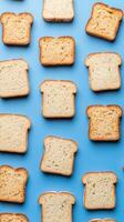 Reduction food waste concept. Toast slices arranged on a blue background in a creative pattern. photo