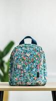 Recycle material advancement concept. Floral-patterned backpack on a table with greenery in the background. photo