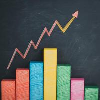 Advice investment tip concept. Colorful bar graph with an upward trend on a chalkboard background. photo