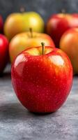 Fresh red apple with glossy skin in front of various apples. photo