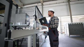 Engineer sets up a production line at programmable CNC machine video