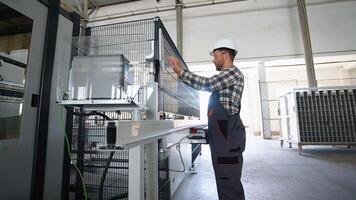 Engineer entering data in CNC machine at pvc window factory to get the production going video