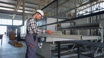 Manual worker assembling PVC windows and doors on production line video