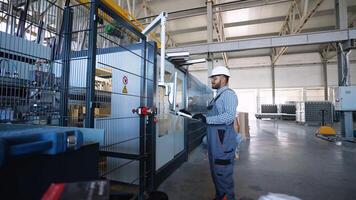 Indian engineer working at programmable CNC machine in factory industries video