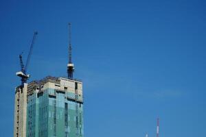 Bangkok, Thailand, 2024 - construction of tall buildings, skyscrapers of bangkok, thailand. on blue sky background photo