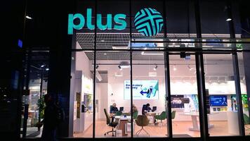 Warsaw, Poland. 22 November 2024. Store front and sign of a store of Plus selling phones and network subscriptions. photo