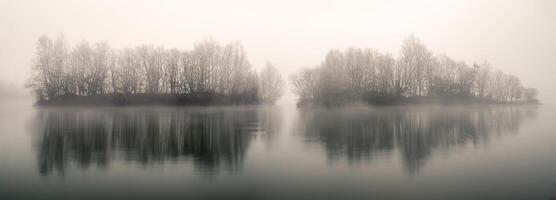 Two small islands covered with forest in the middle of a lagoon photo