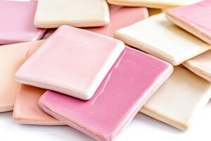 Smooth ceramic tiles in soft pink, dusty rose, and light cream arranged in a geometric pattern for interior design applications photo