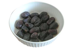 dry fruit in a plastic bowl isolated on white background photo