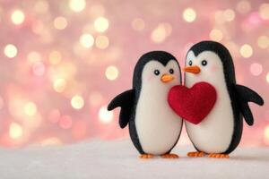 Felted miniature penguins embrace a red heart on a snowy surface with glowing pink and red tones for a charming display of love photo
