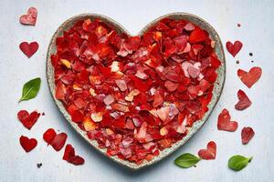 Heart shaped collection of vibrant spices and seasonings displayed on a rustic surface with leaf accents creating a romantic and culinary inspiration photo