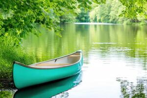 Turquoise canoe resting peacefully along a serene riverbank surrounded by lush greenery and calm reflective waters in nature photo