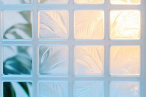 Frosty window patterns illuminated by soft light create a serene atmosphere with delicate textures in pale sky-blue and white-gray hues photo