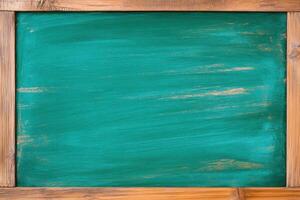 Chalkboard with olive-green background and warm brown wood trim in a simple classroom setting for creative presentations or notes photo