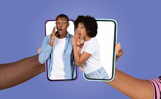 African American couple excitedly engages in a playful whisper, communicating through their smartphones. They express love and connection while enjoying technology in a modern lifestyle setting. photo