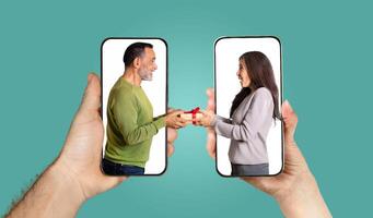 A couple shares a joyful moment as they exchange gifts through a smartphone application. Their hands hold the phones while they engage in a lively chat, illustrating their love. photo