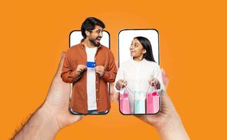 A married couple enjoys shopping online using their smartphones. The man holds a card, while the woman displays colorful shopping bags, showing their connection through technology. photo