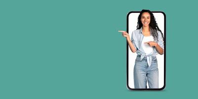 A woman interacts with a smartphone, happily showcasing an online application. The setting features a solid color background, emphasizing the focus on communication technology. photo