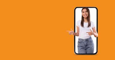 A person with a friendly expression interacts with a large smartphone screen. They are highlighting features related to communication and technology, set against a vibrant background. photo