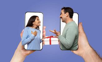 A married couple expresses affection and happiness while chatting on their smartphones, sharing a surprise gift via a call. Their smiles and gestures show deep connection despite the distance. photo