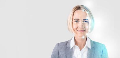 A woman with short blonde hair smiles while facial recognition technology digitally maps her face. The background is plain, emphasizing her expression and the innovative tech. photo