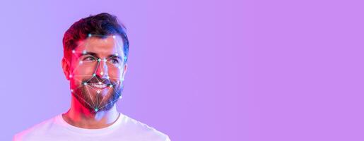 A smiling man with facial recognition technology applied, showcasing detailed identification features. Colorful lighting enhances the modern context of biometric analysis in a studio setting. photo