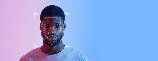 Man is engaged in facial recognition technology. His face is highlighted by a grid overlay, which signifies identification processes in a high-tech context. photo