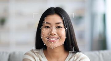 A woman with long hair smiles at the camera while facial recognition technology analyzes her features. The background features a cozy indoor setting, emphasizing comfort and warmth. photo