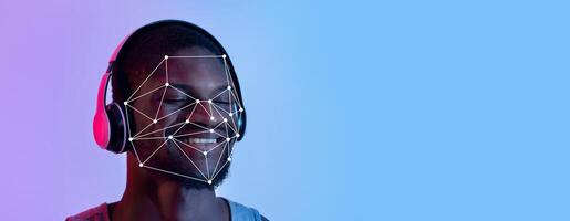 A person wearing headphones experiences facial recognition technology, showcasing a network of data points over their face. photo