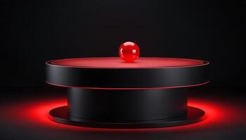 A red ball sits on top of a black table photo